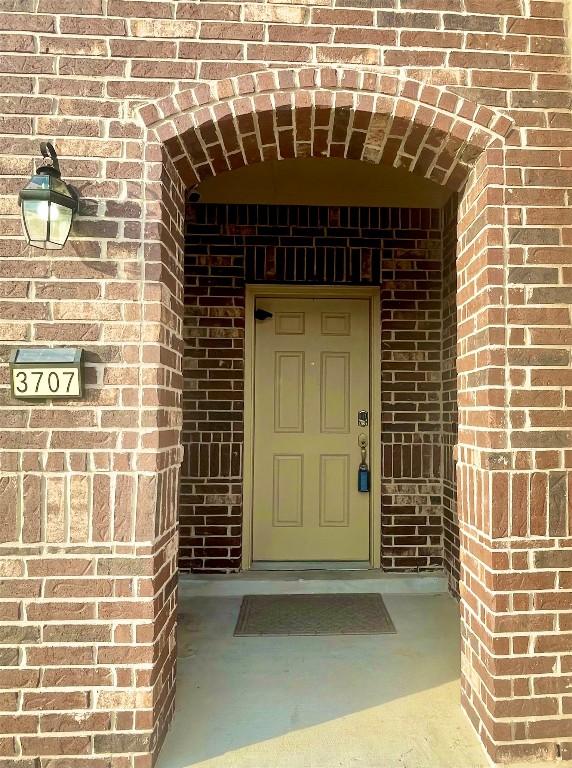 entrance to property with brick siding