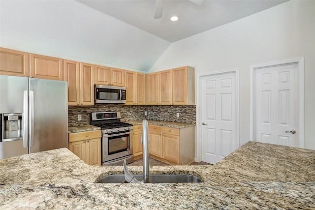 kitchen featuring tasteful backsplash, appliances with stainless steel finishes, light stone counters, and light brown cabinetry