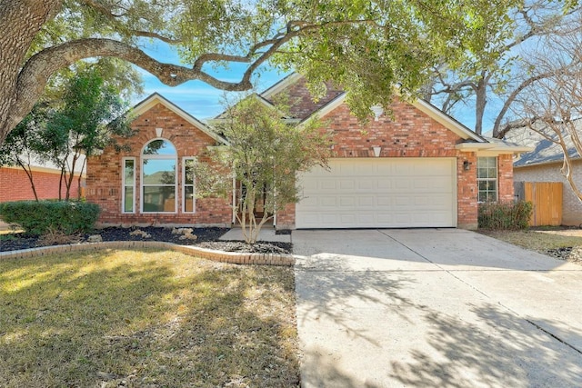 view of front of property featuring concrete driveway, brick siding, an attached garage, and fence