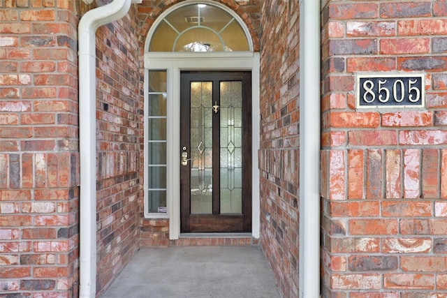 entrance to property with brick siding