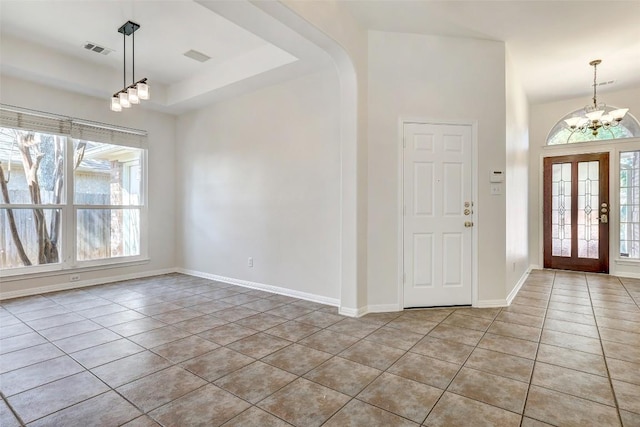 foyer with light tile patterned floors, a chandelier, visible vents, and baseboards