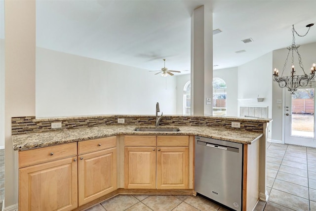 kitchen with light stone counters, light brown cabinets, a sink, visible vents, and dishwasher