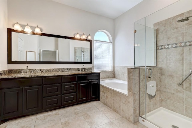 full bathroom featuring a garden tub, a sink, a shower stall, and double vanity