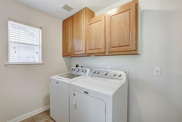 washroom with light tile patterned floors, cabinet space, visible vents, washer and dryer, and baseboards