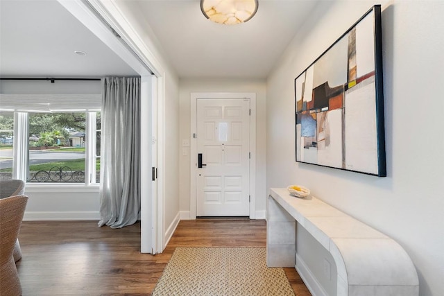 foyer featuring wood finished floors and baseboards