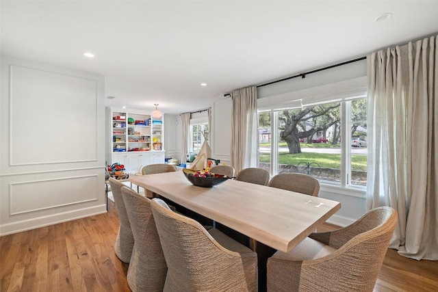 dining room with light wood-type flooring and recessed lighting