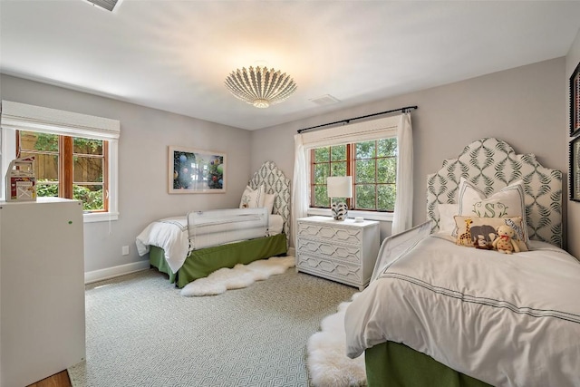 bedroom featuring carpet floors, visible vents, and baseboards