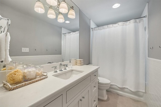 full bath featuring a notable chandelier, shower / bathtub combination with curtain, toilet, vanity, and tile patterned floors