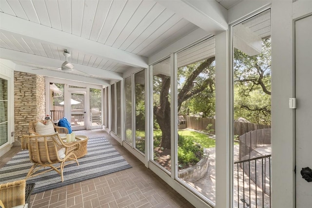 sunroom / solarium with wood ceiling, beamed ceiling, and a wealth of natural light