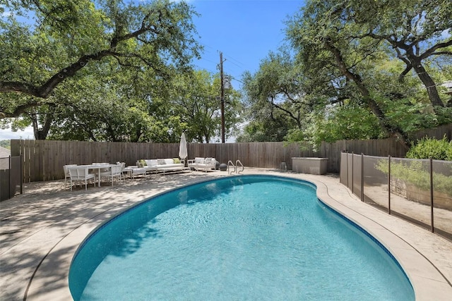 view of pool featuring a patio, outdoor lounge area, a fenced backyard, and a fenced in pool