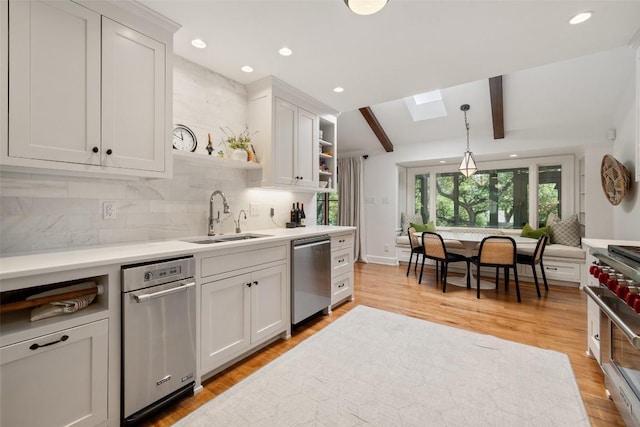 8712 Mountain Ridge Dr, Austin, TX 78759 - kitchen featuring appliances with stainless steel finishes, open shelves, a sink, decorative backsplash, and light countertops