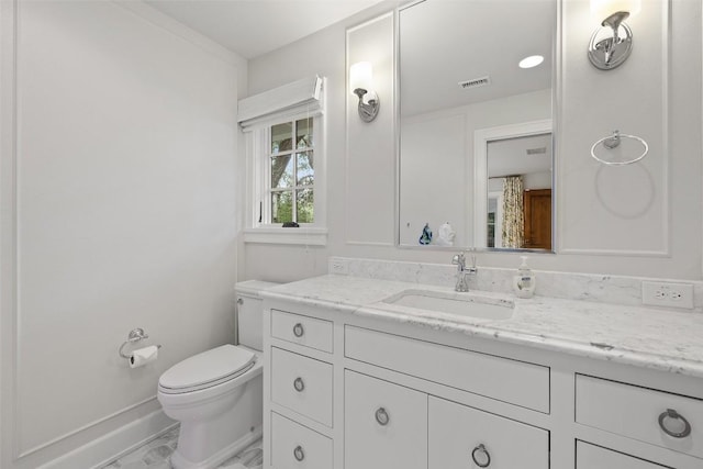 half bath with visible vents, vanity, and toilet