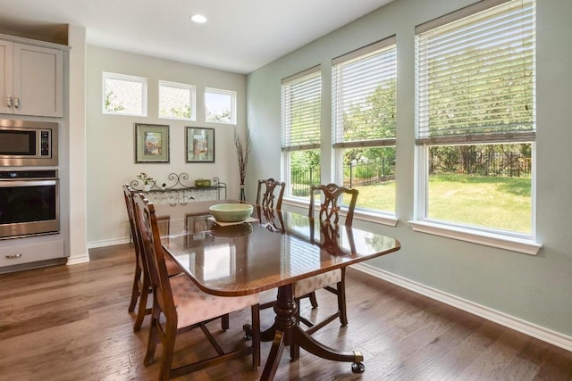 dining space with dark wood-style floors, baseboards, and recessed lighting