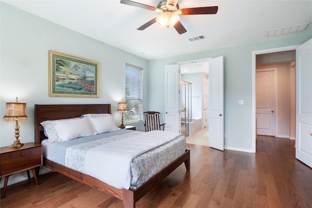 bedroom with a ceiling fan, wood finished floors, visible vents, and baseboards