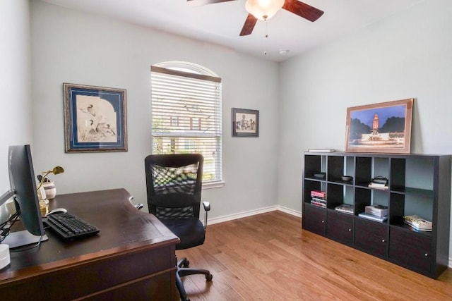 office area with wood finished floors, a ceiling fan, and baseboards