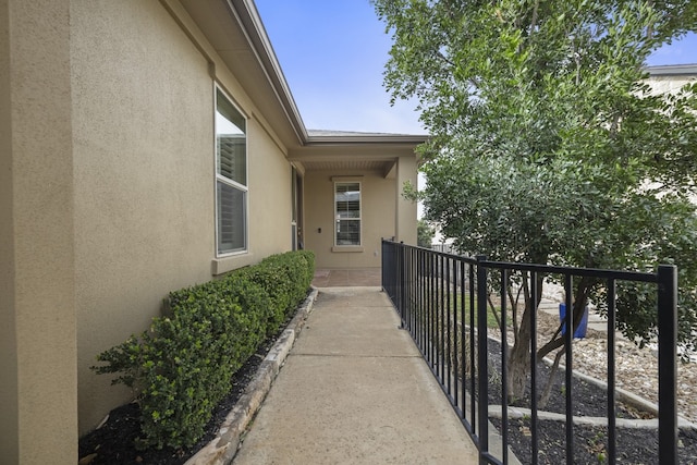 property entrance with stucco siding and a balcony