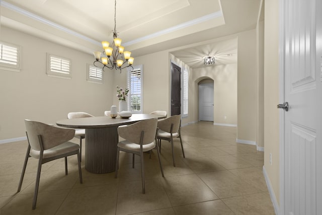 224 Tavish Trl, Austin, TX 78738 - dining area with arched walkways, a chandelier, a raised ceiling, tile patterned floors, and baseboards