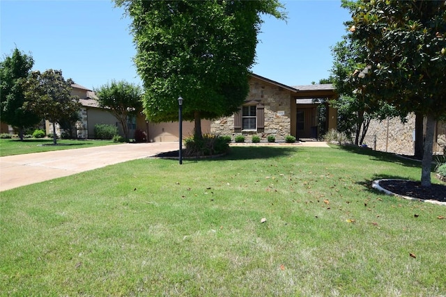 224 Tavish Trl, Austin, TX 78738 - view of front facade with stone siding, driveway, and a front lawn