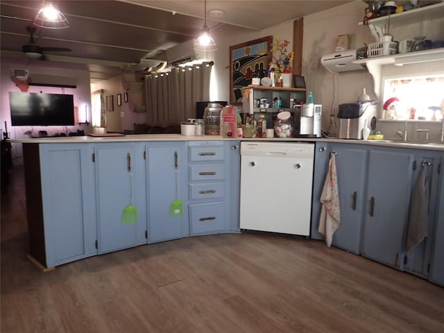 kitchen featuring wood finished floors, a peninsula, blue cabinets, white dishwasher, and open shelves