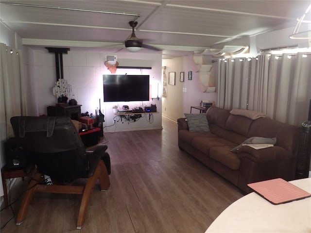 living area with a wall mounted AC and wood finished floors