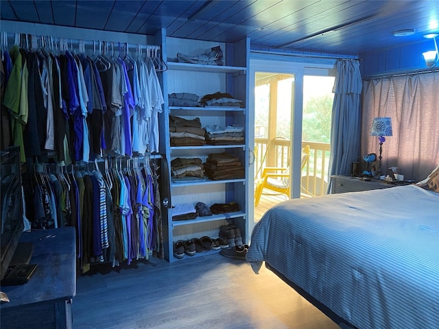 bedroom featuring a closet, wooden ceiling, and wood finished floors