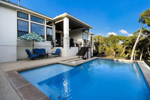 view of swimming pool featuring a fenced in pool, outdoor lounge area, stairway, a patio area, and fence