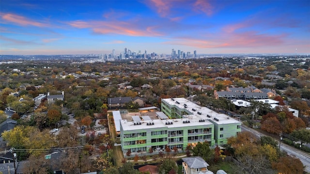 aerial view at dusk featuring a city view