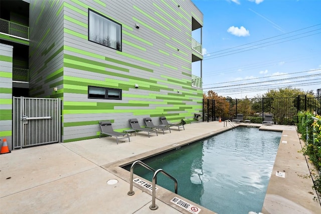 pool featuring a patio area and fence