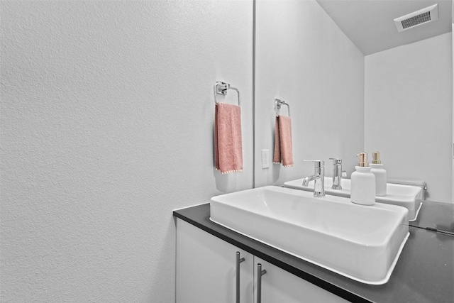 bathroom with a sink and visible vents