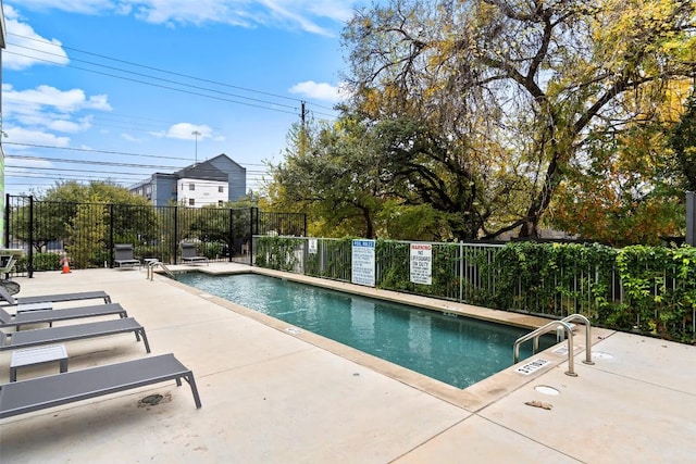 pool featuring a patio and fence