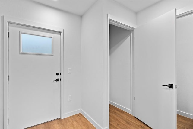 entrance foyer featuring baseboards and light wood-style floors