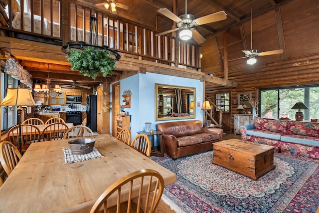 dining space featuring wooden ceiling, beamed ceiling, stairs, log walls, and high vaulted ceiling