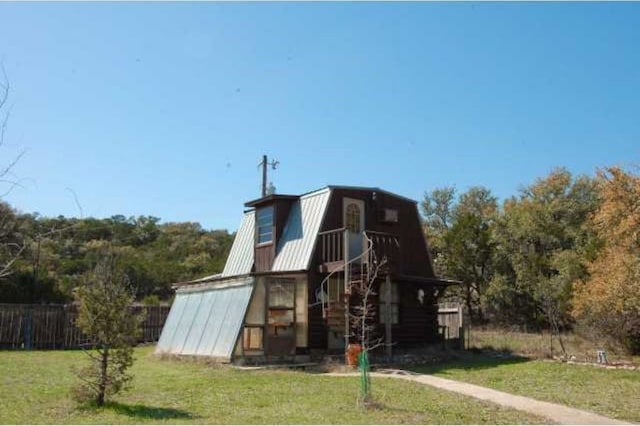 view of jungle gym with a lawn and fence