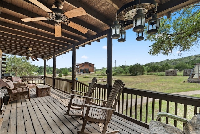 deck with ceiling fan and a yard