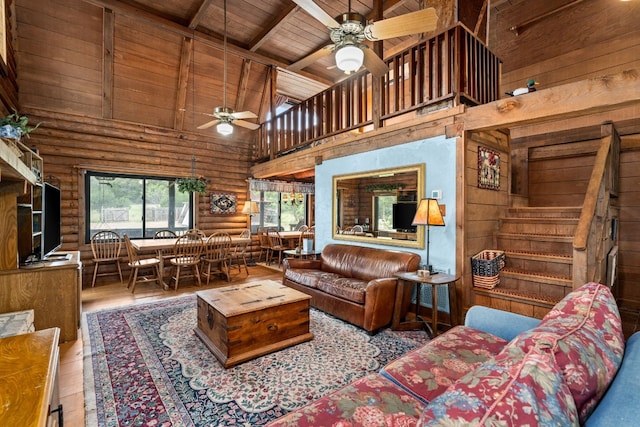 living room featuring beam ceiling, ceiling fan, wood finished floors, high vaulted ceiling, and wooden ceiling