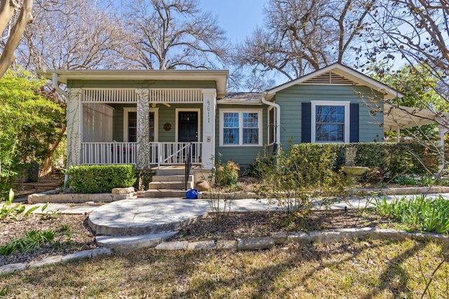 single story home with a porch