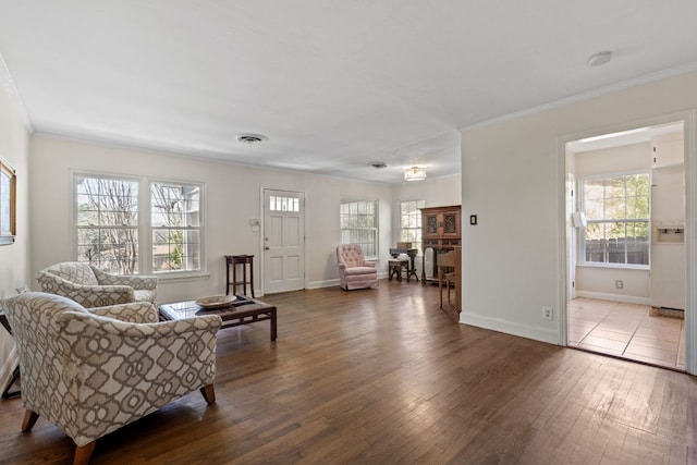 interior space featuring a wealth of natural light, hardwood / wood-style floors, visible vents, and crown molding