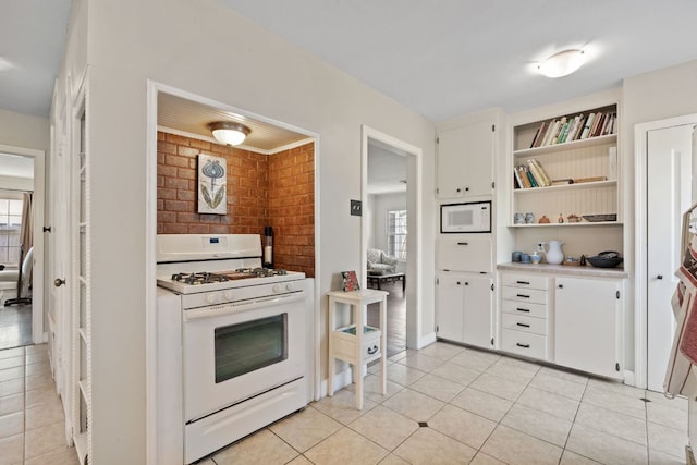 kitchen featuring white appliances, light tile patterned floors, light countertops, white cabinetry, and open shelves