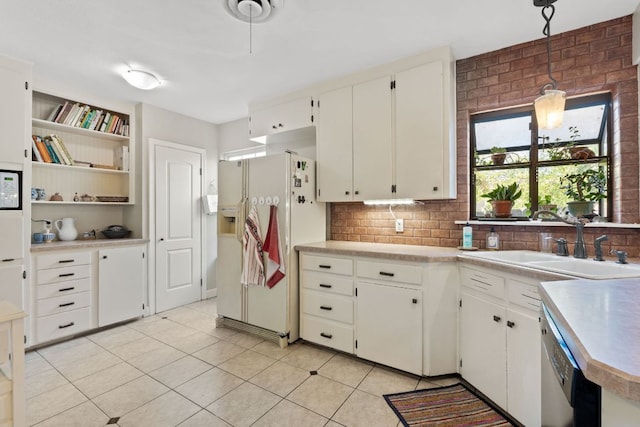 kitchen featuring light countertops, decorative backsplash, a sink, white fridge with ice dispenser, and dishwasher