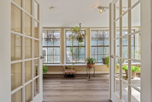 unfurnished sunroom with french doors