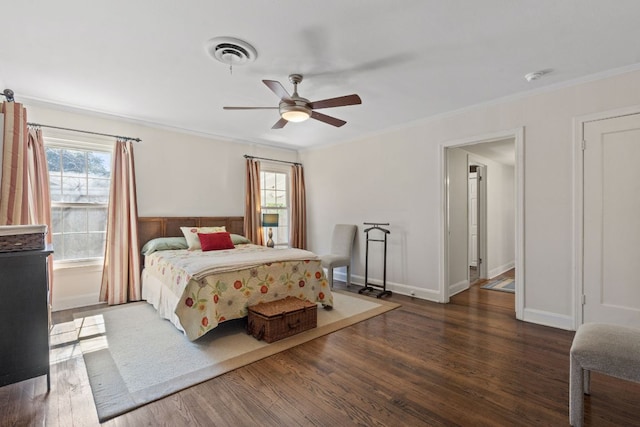 bedroom with baseboards, visible vents, ceiling fan, ornamental molding, and wood finished floors