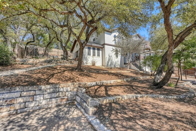 exterior space featuring fence and stucco siding