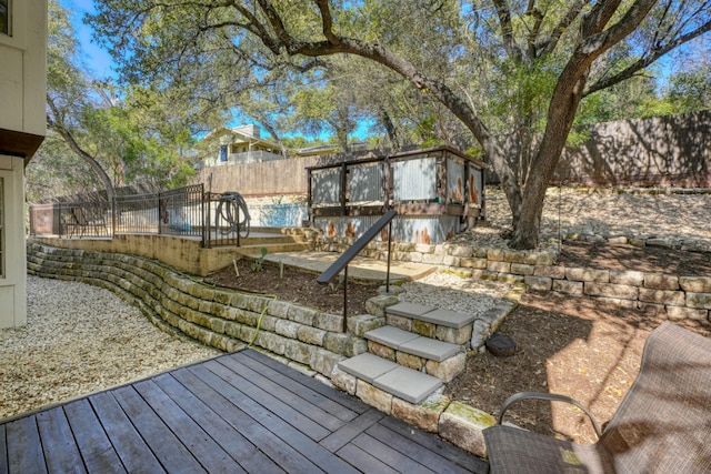 deck with an outbuilding and a fenced backyard