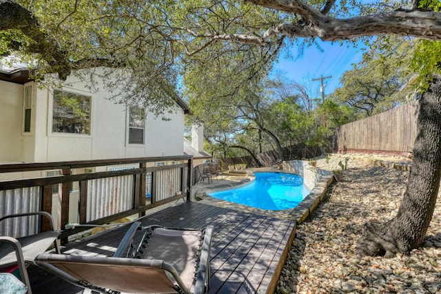 view of swimming pool with a fenced in pool, a fenced backyard, and a deck