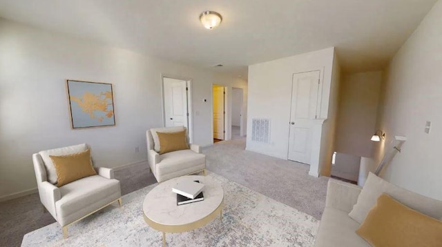 living area featuring carpet floors and visible vents