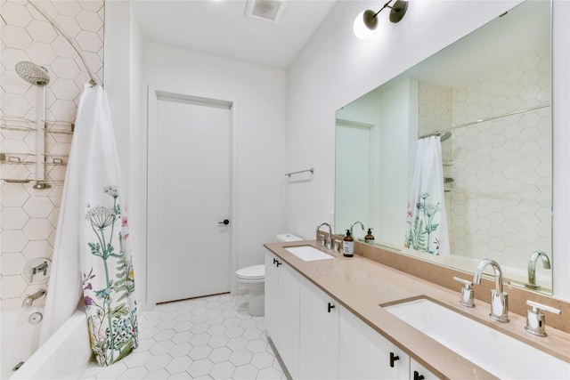 full bath with visible vents, a sink, toilet, and tile patterned floors