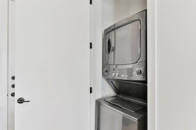 laundry room featuring laundry area and stacked washer / dryer