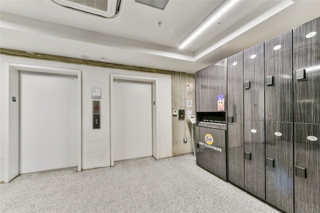 interior space featuring speckled floor and elevator