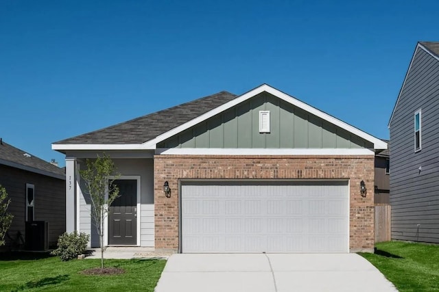 view of front facade with a garage, driveway, central air condition unit, board and batten siding, and brick siding