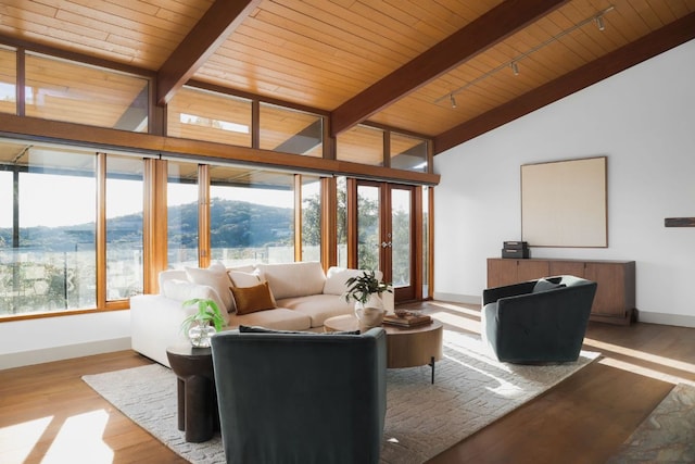 1400 Mount Larson Rd, Austin, TX 78746 - living room with wooden ceiling with exposed beams, baseboards, wood finished floors, and high vaulted ceiling